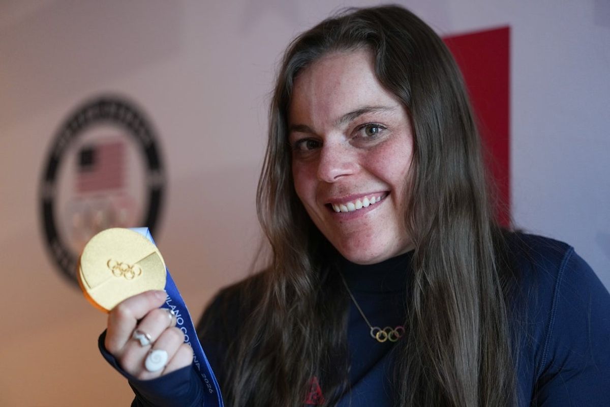 Feb 9, 2026; Cortina d'Ampezzo, Italy; United States skier Breezy Johnson poses for a photo with her gold medal during the Milano Cortina 2026 Olympic Winter Games at Hotel Tofana Cortina. Mandatory Credit: Eric Bolte-Imagn Images