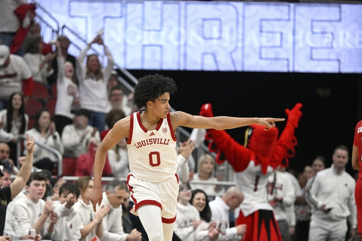 Feb 9, 2026; Louisville, Kentucky, USA;  Louisville Cardinals guard Mikel Brown Jr. (0) reacts after making a shot against the NC State Wolfpack during the first half at KFC Yum! Center. Mandatory Credit: Jamie Rhodes-Imagn Images