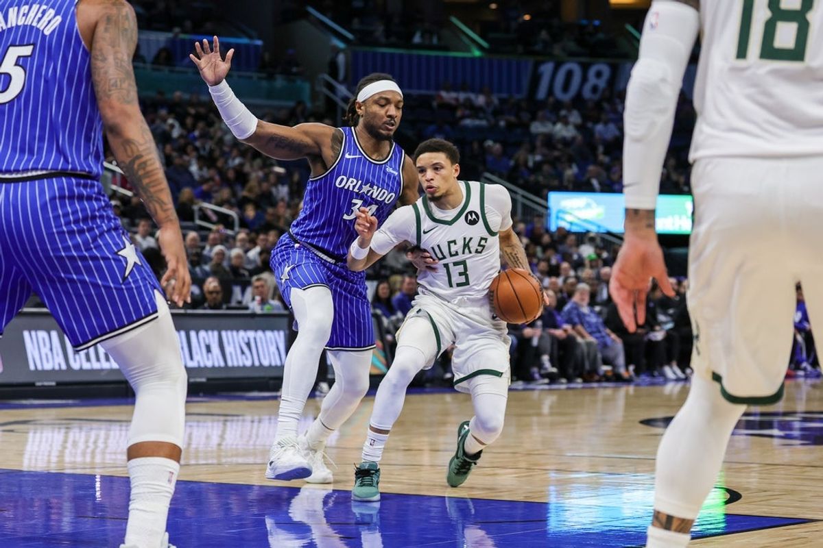 Feb 9, 2026; Orlando, Florida, USA; Milwaukee Bucks guard Ryan Rollins (13) drives around Orlando Magic center Wendell Carter Jr. (34) during the first quarter at Kia Center. Mandatory Credit: Mike Watters-Imagn Images