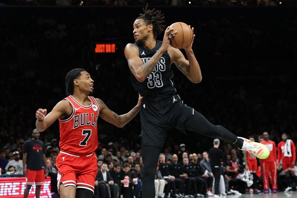 Feb 9, 2026; Brooklyn, New York, USA; Brooklyn Nets center Nic Claxton (33) is guarded by Chicago Bulls guard Rob Dillingham (7) during the second half at Barclays Center. Mandatory Credit: Vincent Carchietta-Imagn Images