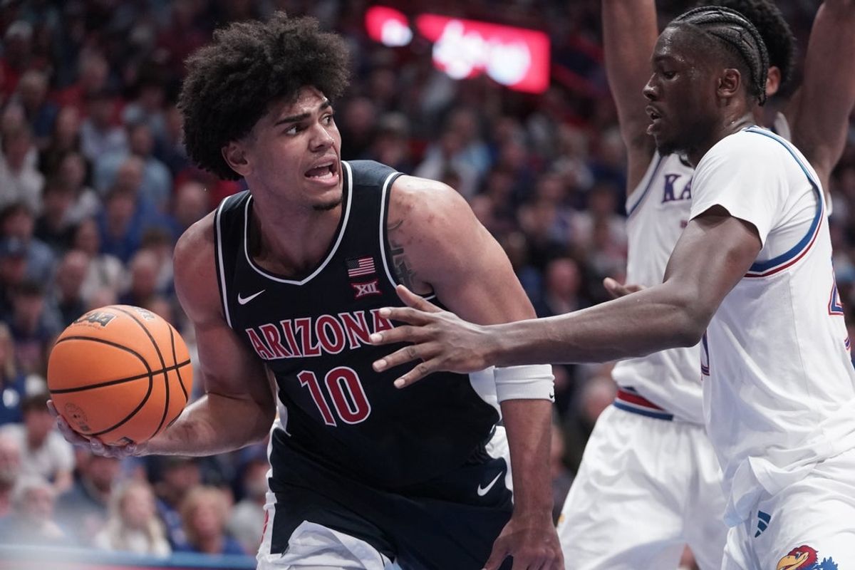 Arizona Wildcats forward Koa Peat (10) looks for a pass against Kansas Jayhawks during the game inside Allen Fieldhouse on Feb. 9, 2026.
