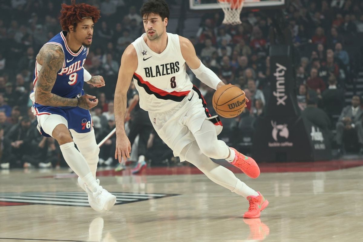 Feb 9, 2026; Portland, Oregon, USA;  Portland Trail Blazers forward Deni Avdija (8) dribbles the ball past Philadelphia 76ers forward/guard Kelly Oubre Jr. (9) during the first half at Moda Center. Mandatory Credit: Jaime Valdez-Imagn Images