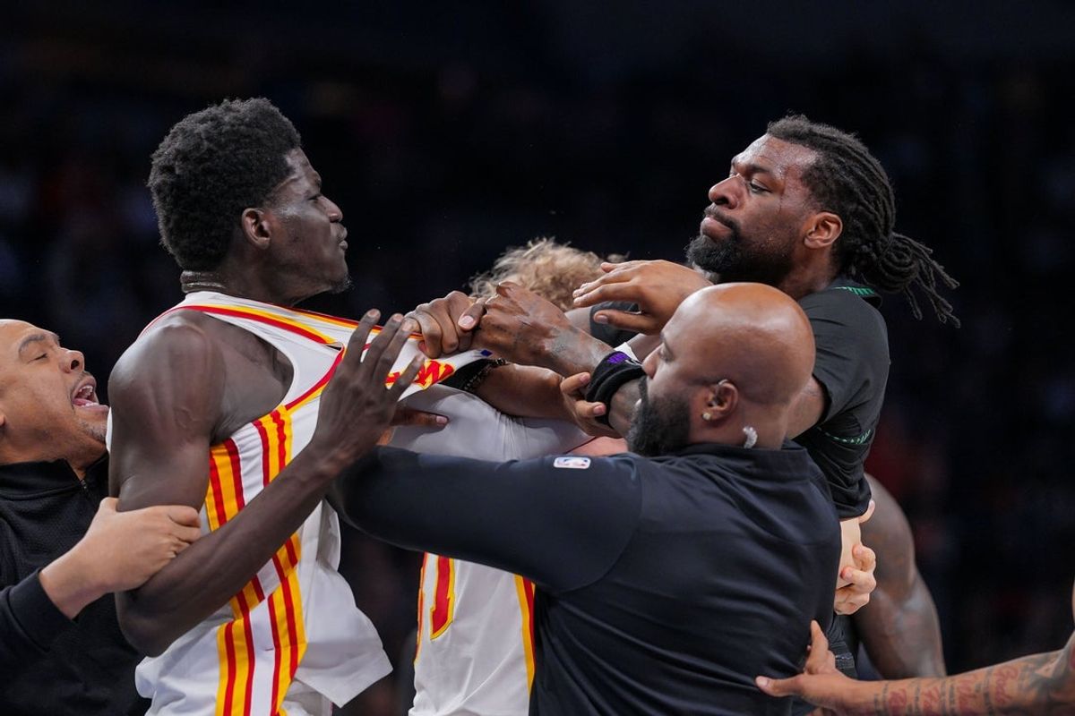 Feb 9, 2026; Minneapolis, Minnesota, USA; Atlanta Hawks forward Mouhamed Gueye (18) and Minnesota Timberwolves center Naz Reid (11) push each other in the fourth quarter at Target Center. Mandatory Credit: Brad Rempel-Imagn Images