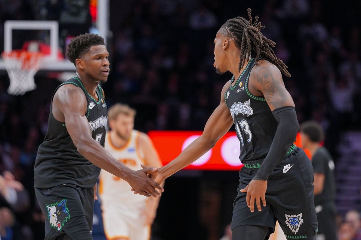 Feb 9, 2026; Minneapolis, Minnesota, USA; Minnesota Timberwolves guard Anthony Edwards (5) and guard Ayo Dosunmu (13) celebrate against the Atlanta Hawks in the second quarter at Target Center. Mandatory Credit: Brad Rempel-Imagn Images