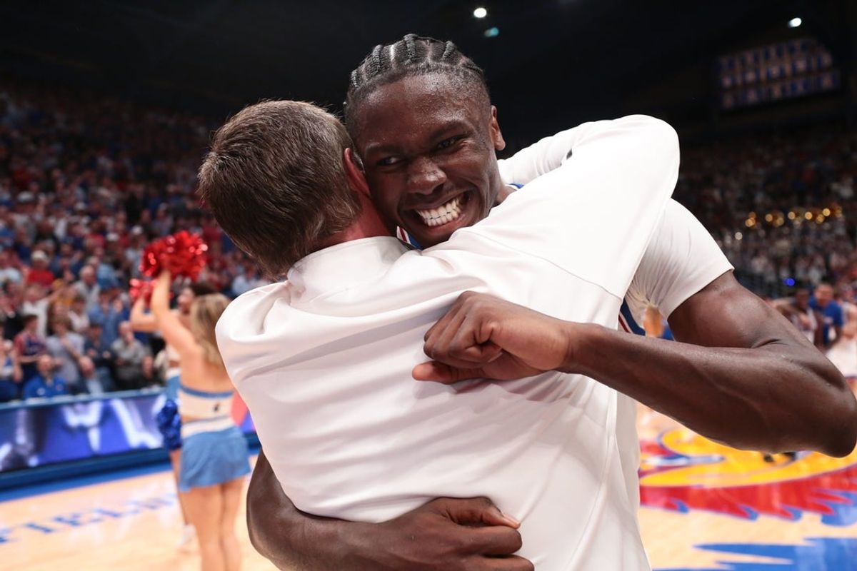 Kansas Jayhawks forward Flory Bidunga (40) hugs Kansas Jayhawks head coach Bill Self after defeating Arizona Wildcats in the game inside Allen Fieldhouse on Feb. 9, 2026.