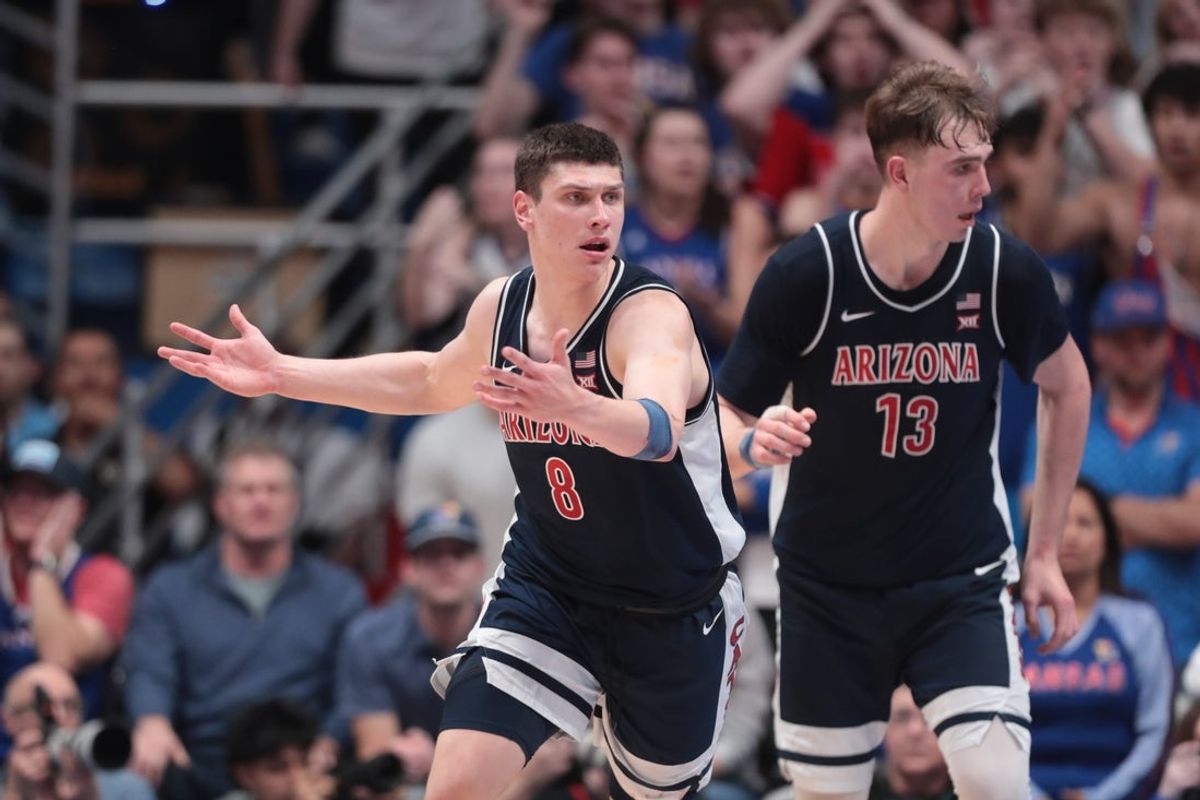 Arizona Wildcats forward Ivan Kharchenkov (8) reacts after scoring against Kansas Jayhawks during the game inside Allen Fieldhouse on Feb. 9, 2026.
