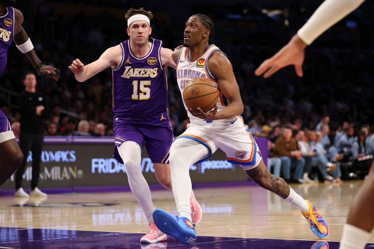 Feb 9, 2026; Los Angeles, California, USA;  Oklahoma City Thunder guard Jalen Williams (8) goes to the basket against Los Angeles Lakers guard Austin Reaves (15) during the first half at Crypto.com Arena. Mandatory Credit: Kiyoshi Mio-Imagn Images