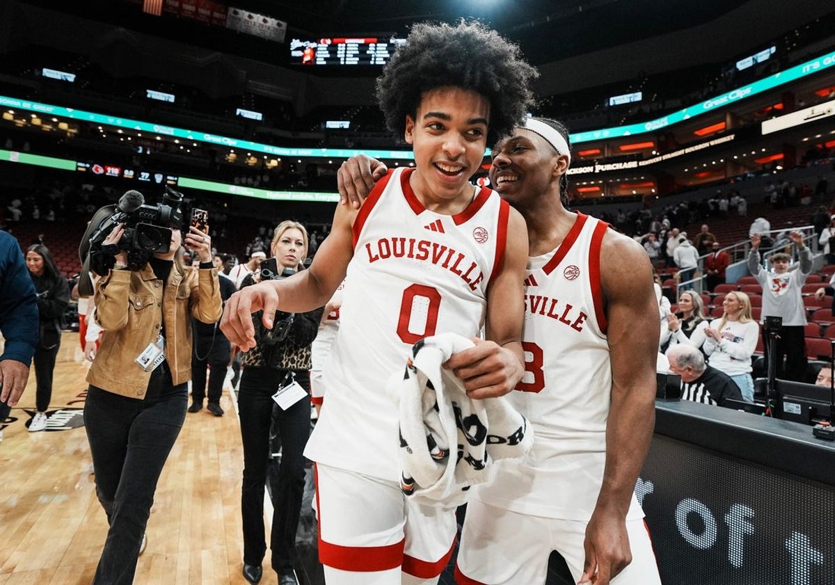 Louisville Cardinals guard Mikel Brown Jr. (0) gets congratulated by teammate Louisville Cardinals guard Ryan Conwell (3) after Brown Jr. scored 45 points with 10-for-16 3-point shooting as the Cards roll past NC State 118-77 at the KFC Yum! Center in downtown Louisville February 9, 2026. Conwell finished with 31 points and six assists.