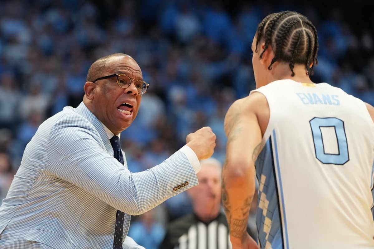 Feb 7, 2026; Chapel Hill, North Carolina, USA;  North Carolina Tar Heels head coach Hubert Davis with guard Kyan Evans (0) in the first half at Dean E. Smith Center. Mandatory Credit: Bob Donnan-Imagn Images