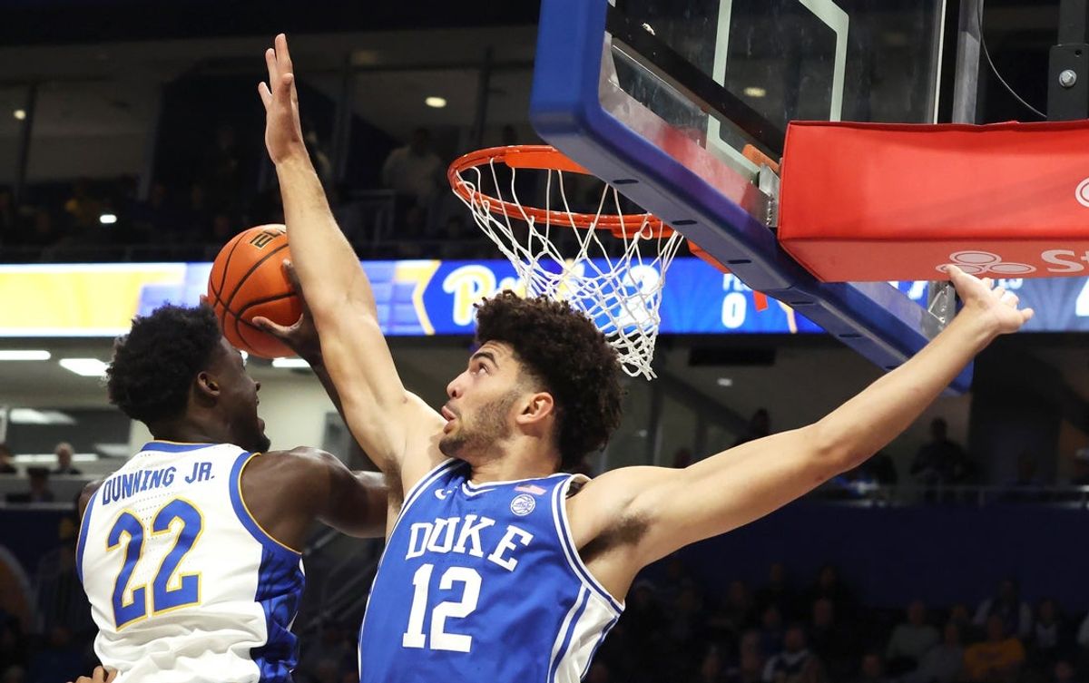 Feb 10, 2026; Pittsburgh, Pennsylvania, USA;  Pittsburgh Panthers guard Barry Dunning Jr. (22) shoots against Duke Blue Devils forward Cameron Boozer (12) during the first half at Petersen Events Center. Mandatory Credit: Charles LeClaire-Imagn Images