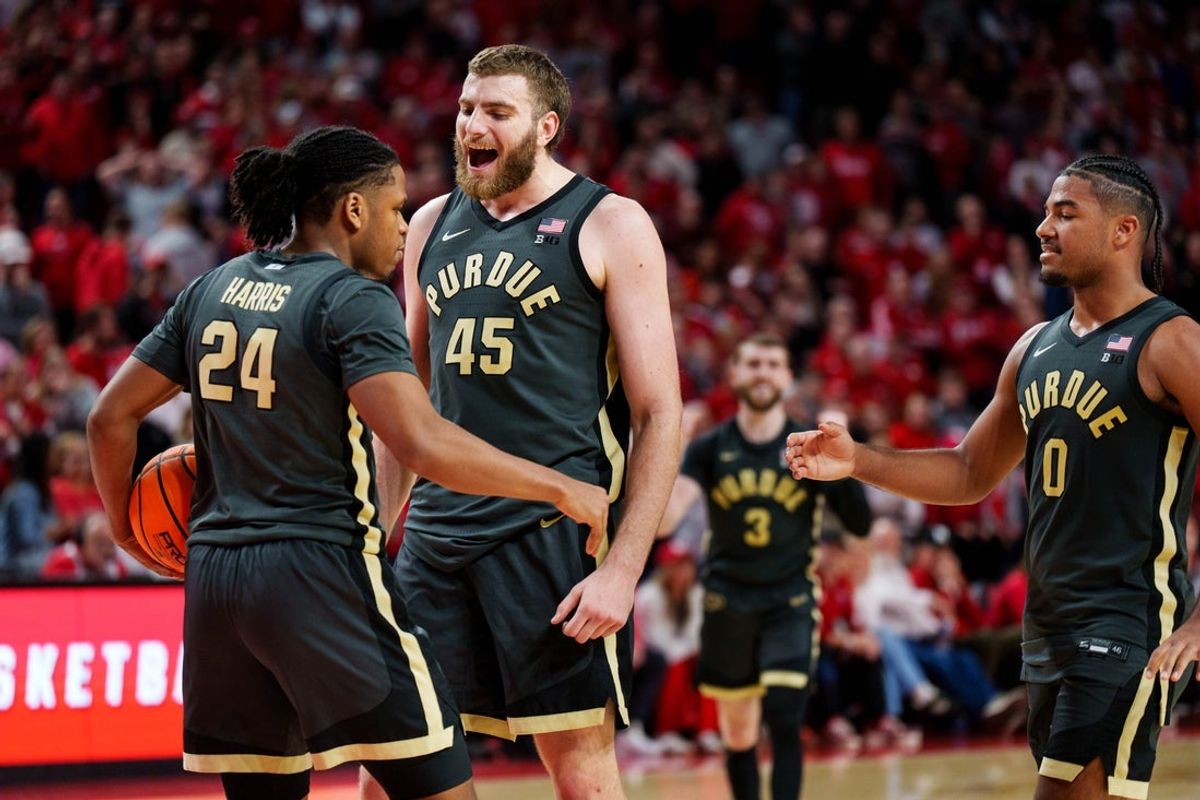 Feb 10, 2026; Lincoln, Nebraska, USA; Purdue Boilermakers guard Gicarri Harris (24), center Oscar Cluff (45) and guard C.J. Cox (0) celebrate after a foul by the Nebraska Cornhuskers during overtime at Pinnacle Bank Arena. Mandatory Credit: Dylan Widger-Imagn Images