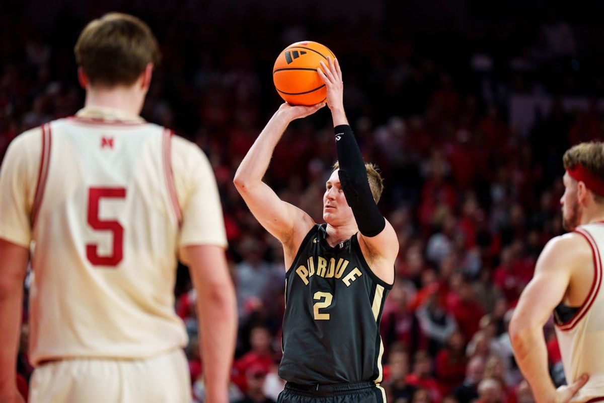 Feb 10, 2026; Lincoln, Nebraska, USA; Purdue Boilermakers guard Fletcher Loyer (2) shoots a free throw against Nebraska Cornhuskers forward Braden Frager (5) and guard Sam Hoiberg (1) during the second half at Pinnacle Bank Arena. Mandatory Credit: Dylan Widger-Imagn Images