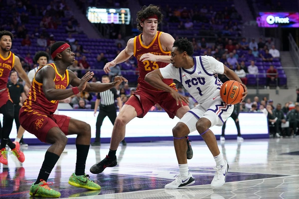 Feb 10, 2026; Fort Worth, Texas, USA;  TCU Horned Frogs guard Jayden Pierre (1) looks to create space in the lane as Iowa State Cyclones forward Blake Buchanan (23) defends during the first half at Ed and Rae Schollmaier Arena. Mandatory Credit: Raymond Carlin III-Imagn Images