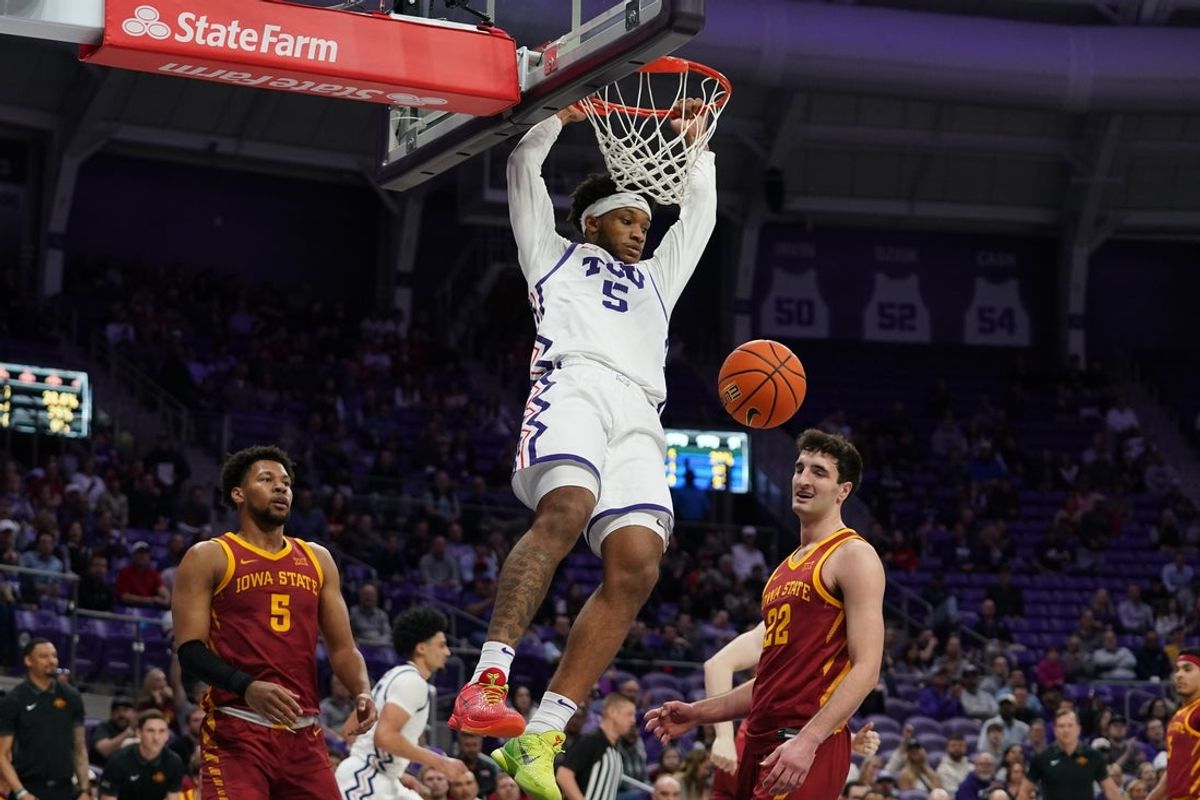 Feb 10, 2026; Fort Worth, Texas, USA;  TCU Horned Frogs forward Micah Robinson (5) follows through on a dunk as Iowa State Cyclones forward Joshua Jefferson (5) and forward Milan Momcilovic (22) look on during the first half at Ed and Rae Schollmaier Arena. Mandatory Credit: Raymond Carlin III-Imagn Images