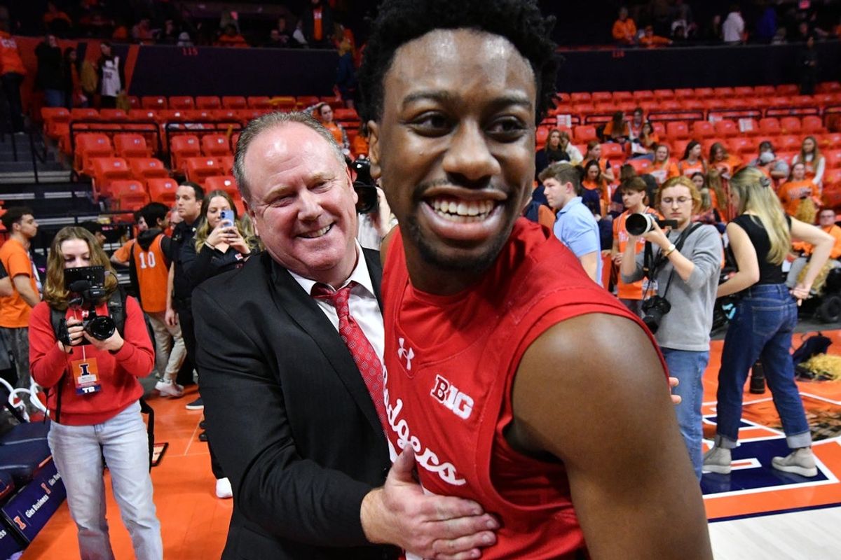 Feb 10, 2026; Champaign, Illinois, USA;  Wisconsin Badgers head coach Greg Gard gives a hand to player Wisconsin Badgers guard John Blackwell (25) after a win over the Illinois Fighting Illini during the second half at State Farm Center. Mandatory Credit: Ron Johnson-Imagn Images