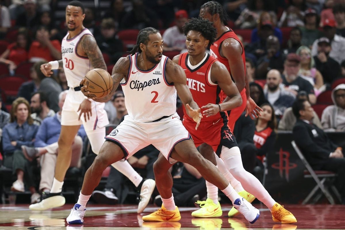 Feb 10, 2026; Houston, Texas, USA; Los Angeles Clippers forward Kawhi Leonard (2) controls the ball as Houston Rockets guard Amen Thompson (1) defends during the third quarter at Toyota Center. Mandatory Credit: Troy Taormina-Imagn Images