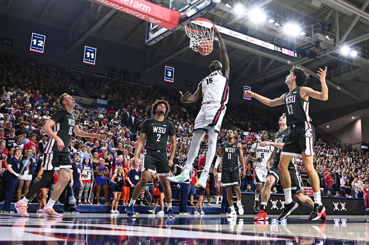 Feb 10, 2026; Spokane, Washington, USA; Gonzaga Bulldogs forward Graham Ike (15) dunks the ball against Washington State Cougars forward Eemeli Yalaho (2) in the first half at McCarthey Athletic Center. Mandatory Credit: James Snook-Imagn Images