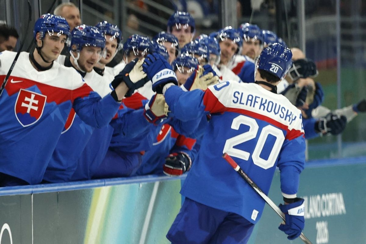 Feb 11, 2026; Milan, Italy;  Juraj Slafkovsky of Slovakia celebrates scoring their third goal with teammates  against Finland in men's ice hockey group B play during the Milano Cortina 2026 Olympic Winter Games at Milano Santagiulia Ice Hockey Arena. Mandatory Credit: Geoff Burke-Imagn Images