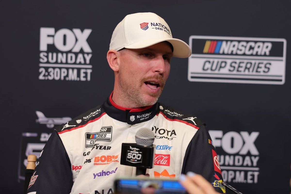 Feb 11, 2026; Daytona Beach, Florida, USA; NASCAR Cup Series driver Denny Hamlin (11) speaks to the media during the Daytona 500 Media Day at Daytona International Speedway. Mandatory Credit: Mike Dinovo-Imagn Images