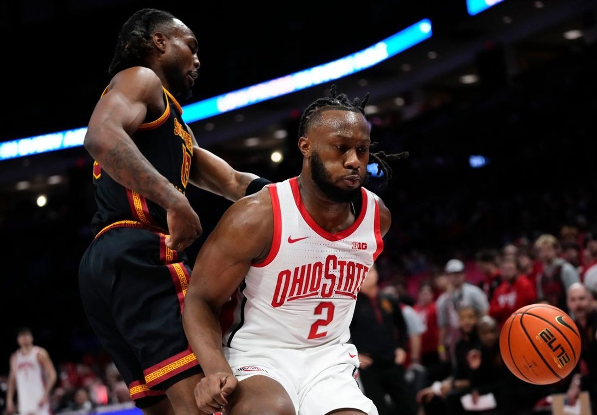 Ohio State Buckeyes guard Bruce Thornton (2) scrambles for a loose ball beside USC Trojans forward Kam Woods (13) during the first half of the NCAA men's basketball game at the Schottenstein Center on Feb. 11, 2026.