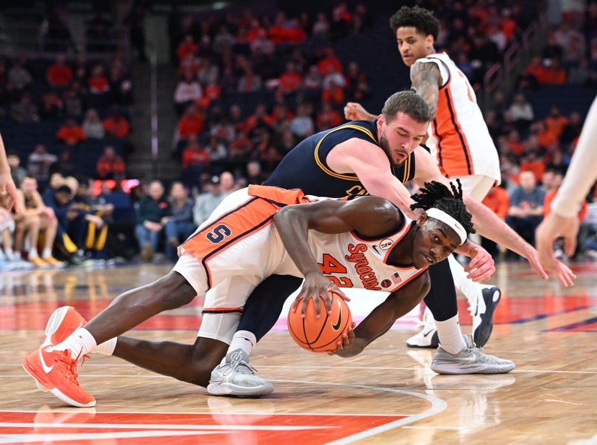 Feb 11, 2026; Syracuse, New York, USA; Syracuse Orange forward William Kyle III (42) gets control of a loose ball in front of California Golden Bears center Milos Ilic (8) in the first half at the JMA Wireless Dome. Mandatory Credit: Mark Konezny-Imagn Images