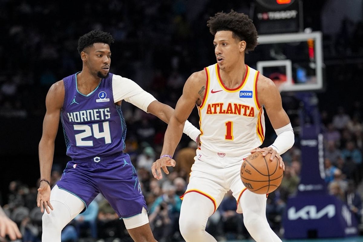 Feb 11, 2026; Charlotte, North Carolina, USA; Atlanta Hawks forward Jalen Johnson (1) handles the ball defended by Charlotte Hornets forward Brandon Miller (24) during first quarter at Spectrum Center. Mandatory Credit: Jim Dedmon-Imagn Images