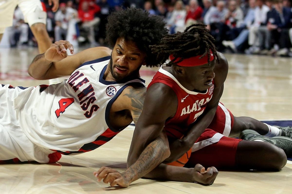 Feb 11, 2026; Oxford, Mississippi, USA; Mississippi Rebels forward James Scott (4) and Alabama Crimson Tide forward Taylor Bol Bowen (7) battle for possession during the first half at The Sandy and John Black Pavilion at Ole Miss. Mandatory Credit: Petre Thomas-Imagn Images