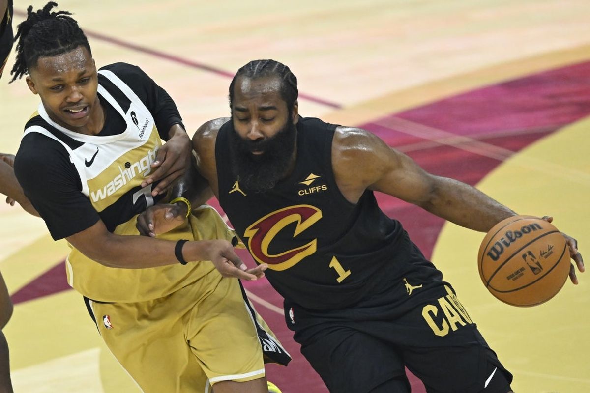 Feb 11, 2026; Cleveland, Ohio, USA; Washington Wizards guard Bub Carrington (7) defends Cleveland Cavaliers guard James Harden (1) in the first quarter at Rocket Arena. Mandatory Credit: David Richard-Imagn Images