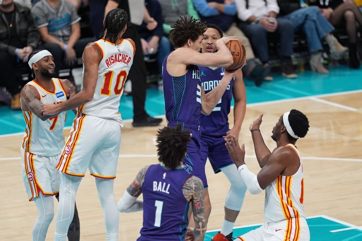 Feb 11, 2026; Charlotte, North Carolina, USA; Charlotte Hornets forward Tidjane Salaun (31) grabs the rebound against the Atlanta Hawks during second quarter at Spectrum Center. Mandatory Credit: Jim Dedmon-Imagn Images