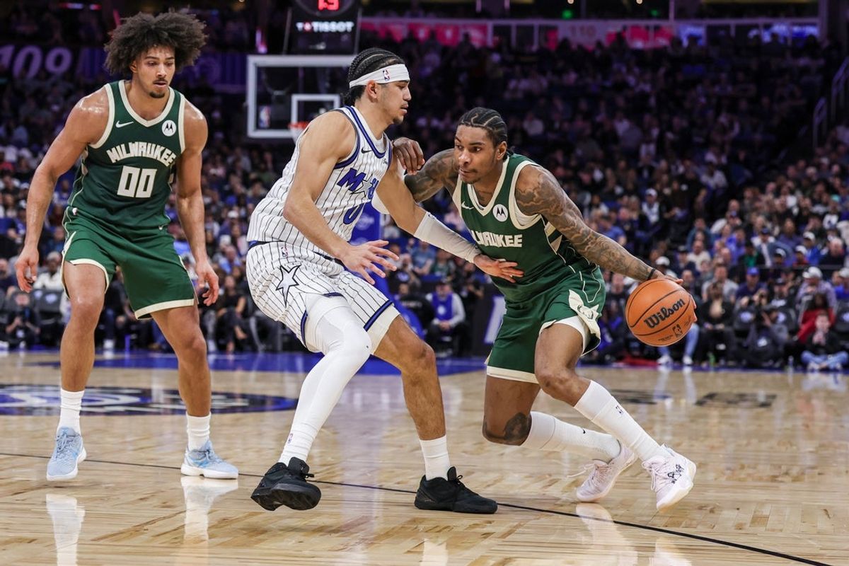 Feb 11, 2026; Orlando, Florida, USA; Milwaukee Bucks guard Kevin Porter Jr. (7) drives around Orlando Magic guard Anthony Black (0) during the second quarter at Kia Center. Mandatory Credit: Mike Watters-Imagn Images