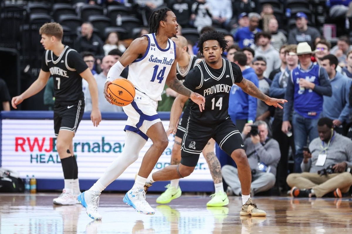 Feb 11, 2026; Newark, New Jersey, USA;  Seton Hall Pirates guard A.J. Staton-McCray (14) looks to drive past Providence Friars guard Jr. Corey Floyd (14) in the first half at Prudential Center. Mandatory Credit: Wendell Cruz-Imagn Images