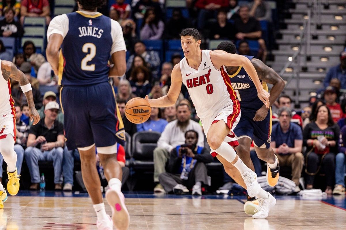 Feb 11, 2026; New Orleans, Louisiana, USA; Miami Heat forward Simone Fontecchio (0) brings the ball up court against New Orleans Pelicans forward Herbert Jones (2) during the first half at Smoothie King Center. Mandatory Credit: Stephen Lew-Imagn Images