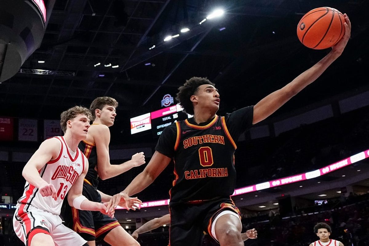 USC Trojans guard Alijah Arenas (0) reaches for a rebound in front of Ohio State Buckeyes center Christoph Tilly (13) and center Gabe Dynes (45) during the second half of the NCAA men's basketball game at the Schottenstein Center on Feb. 11, 2026. Ohio State won 89-82.
