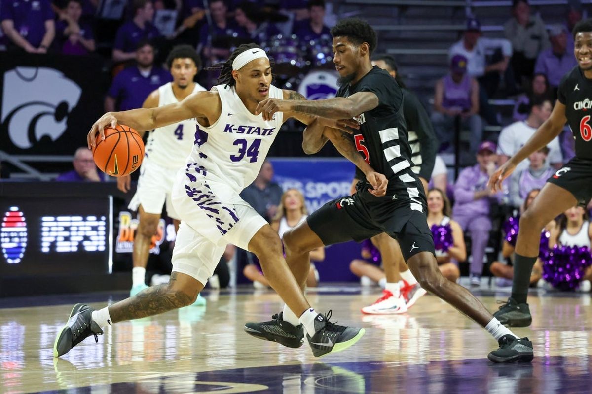 Feb 11, 2026; Manhattan, Kansas, USA; Kansas State Wildcats guard Nate Johnson (34) is guarded by Cincinnati Bearcats guard Sencire Harris (5) during the first half at Bramlage Coliseum. Mandatory Credit: Scott Sewell-Imagn Images