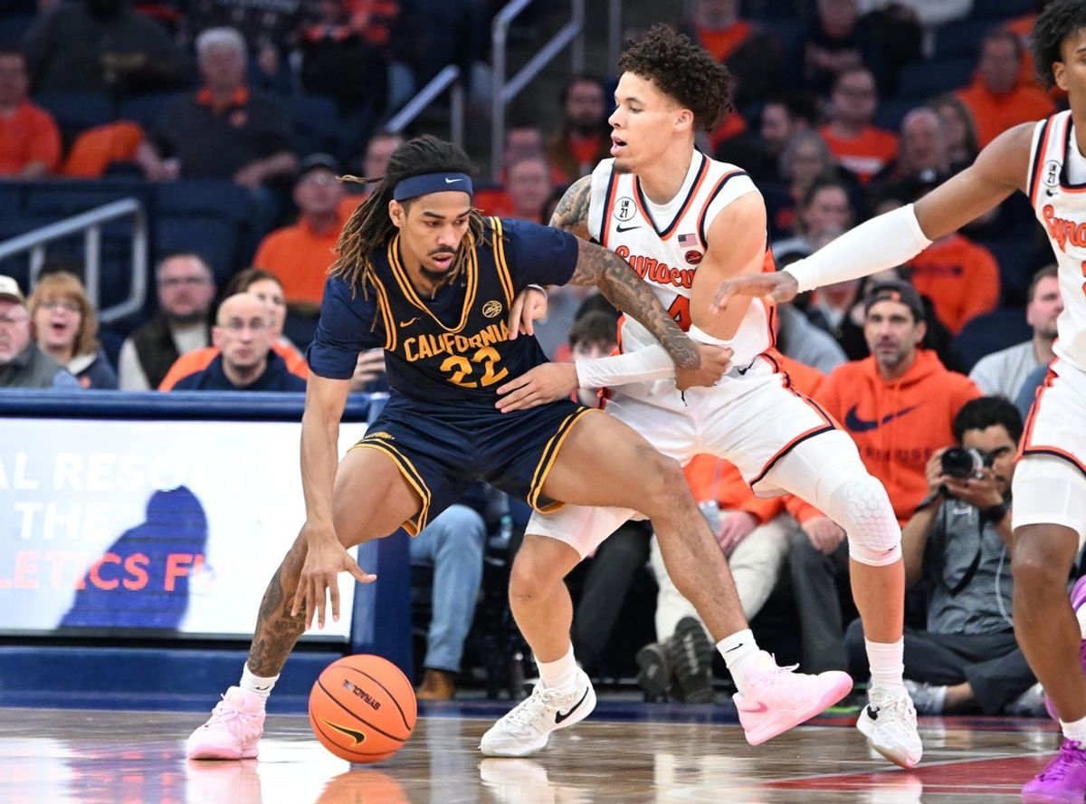 Feb 11, 2026; Syracuse, New York, USA; California Golden Bears forward Chris Bell (22) tries to move past Syracuse Orange guard Nate Kingz (4) in the second half at the JMA Wireless Dome. Mandatory Credit: Mark Konezny-Imagn Images