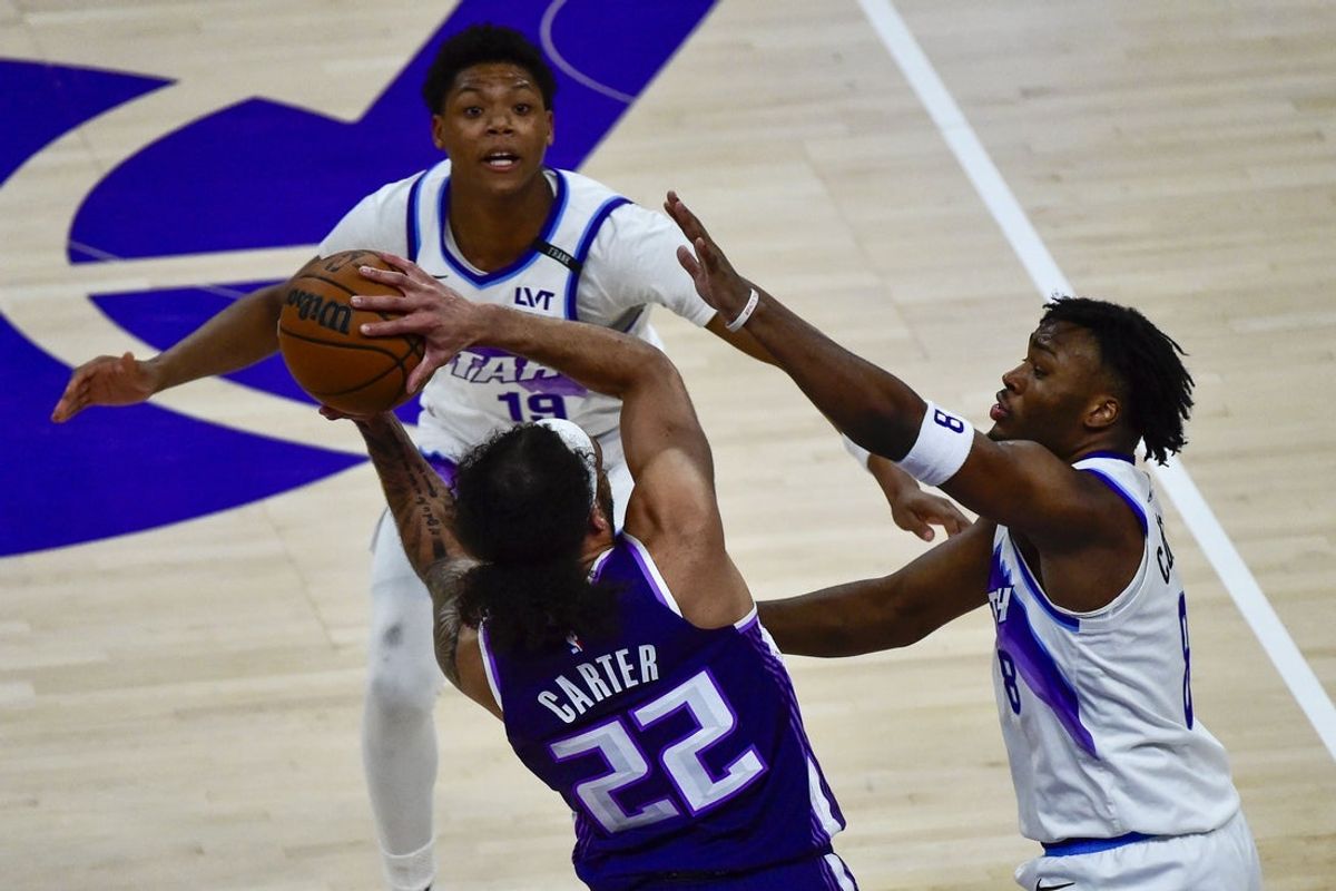 Feb 11, 2026; Salt Lake City, Utah, USA; Sacramento Kings guard Devin Carter (22) gets double teamed by Utah Jazz guard Isaiah Collier (8) and guard Ace Bailey (19) during the first half at Delta Center. Mandatory Credit: Peter Creveling-Imagn Images