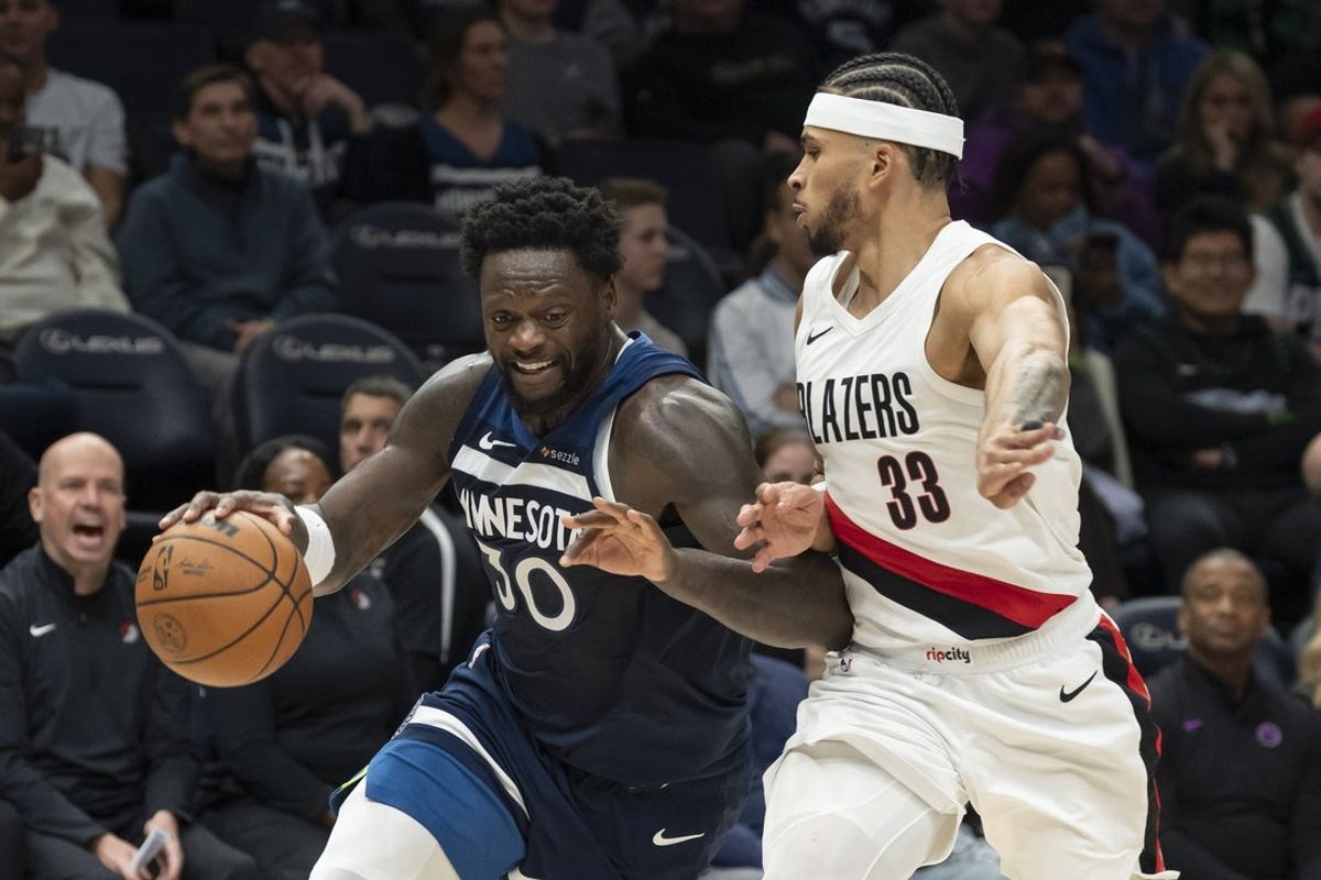 Feb 11, 2026; Minneapolis, Minnesota, USA; Minnesota Timberwolves forward Julius Randle (30) drives to the basket past Portland Trail Blazers forward Toumani Camara (33) in the second half at Target Center. Mandatory Credit: Jesse Johnson-Imagn Images