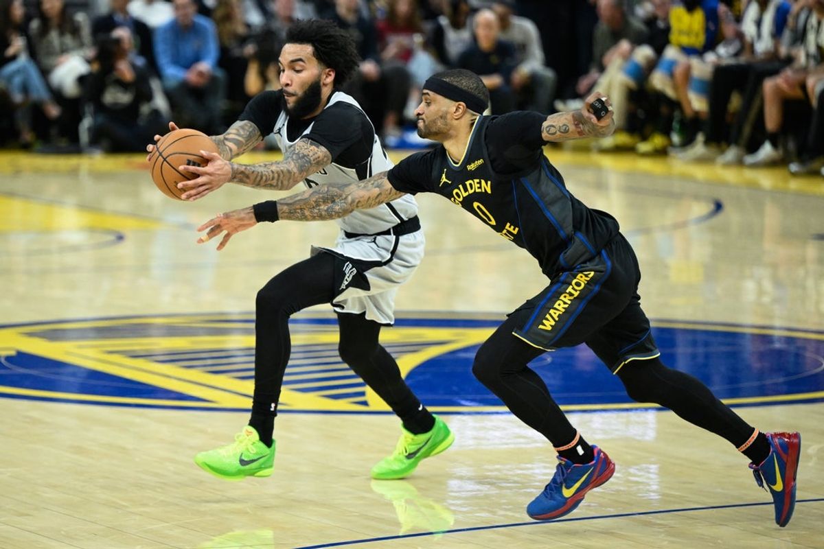 Feb 11, 2026; San Francisco, California, USA; San Antonio Spurs forward Julian Champagnie (30) and Golden State Warriors guard Gary Payton II (0) reach for a loose ball in the second quarter at Chase Center. Mandatory Credit: Eakin Howard-Imagn Images