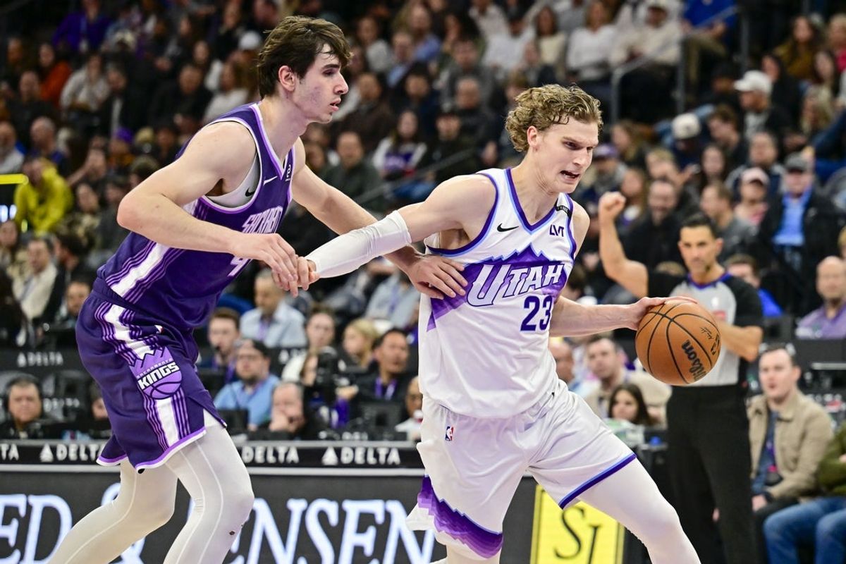 Feb 11, 2026; Salt Lake City, Utah, USA; Utah Jazz forward/center Lauri Markkanen (23) drives into the basket around Sacramento Kings center Maxime Raynaud (42) during the second half at Delta Center. Mandatory Credit: Peter Creveling-Imagn Images