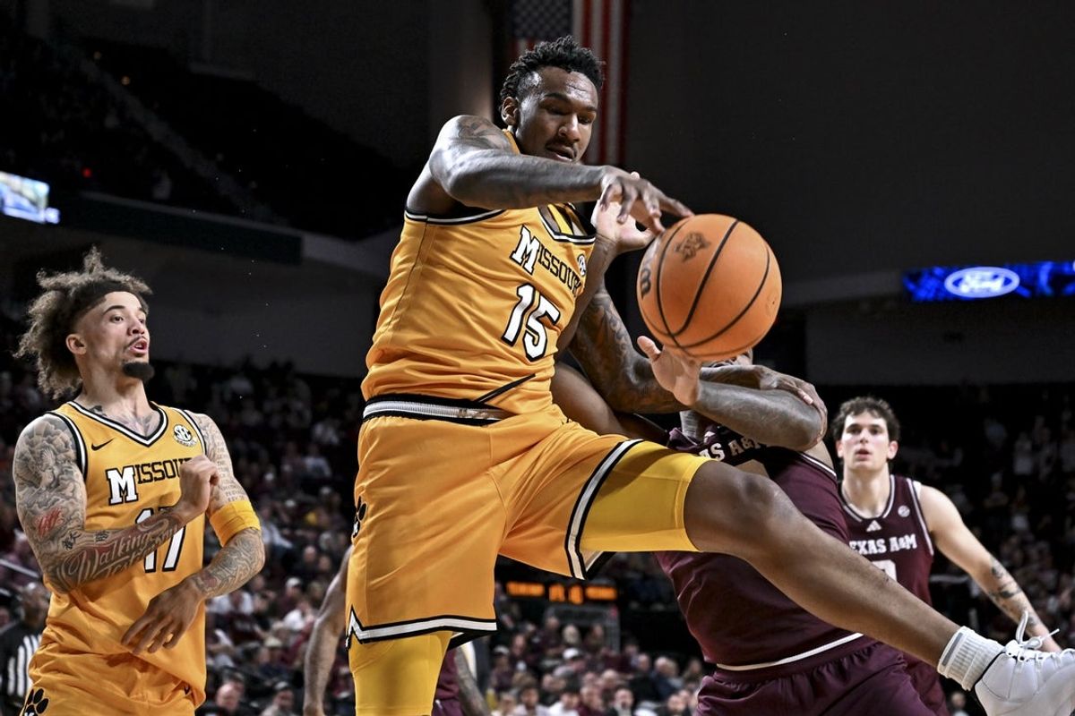 Feb 11, 2026; College Station, Texas, USA; Missouri Tigers center Shawn Phillips Jr. (15) battles for a loose ball against Texas A&M Aggies forward Rashaun Agee (12) during the second half at Reed Arena. Mandatory Credit: Maria Lysaker-Imagn Images