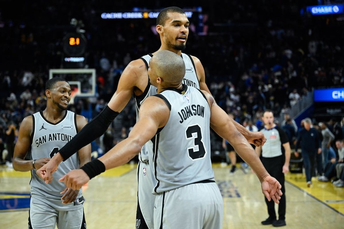 Feb 11, 2026; San Francisco, California, USA; San Antonio Spurs forward Victor Wembanyama (1), forward Keldon Johnson (3), and guard De'Aaron Fox (4) celebrate as the clock expires against the Golden State Warriors in the fourth quarter at Chase Center. Mandatory Credit: Eakin Howard-Imagn Images