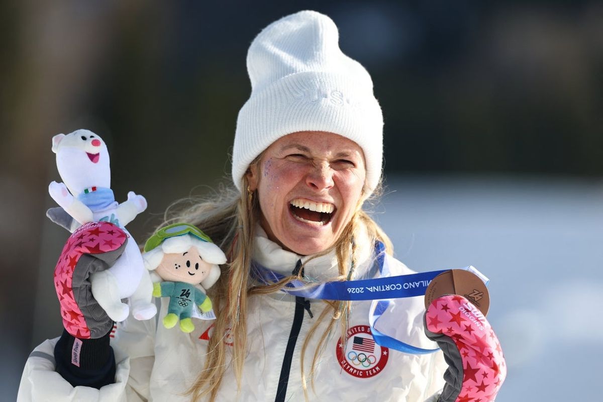 [US, Mexico & Canada customers only] Feb 12, 2026; Tesero, Italy; Bronze medalist Jessie Diggins of the United States celebrates after the women's cross country skiing 10km interval start freestyle during the Milano Cortina 2026 Olympic Winter Games at Tesero Cross-Country Skiing Stadium. Mandatory Credit: Kai Pfaffenbach/Reuters via Imagn Images