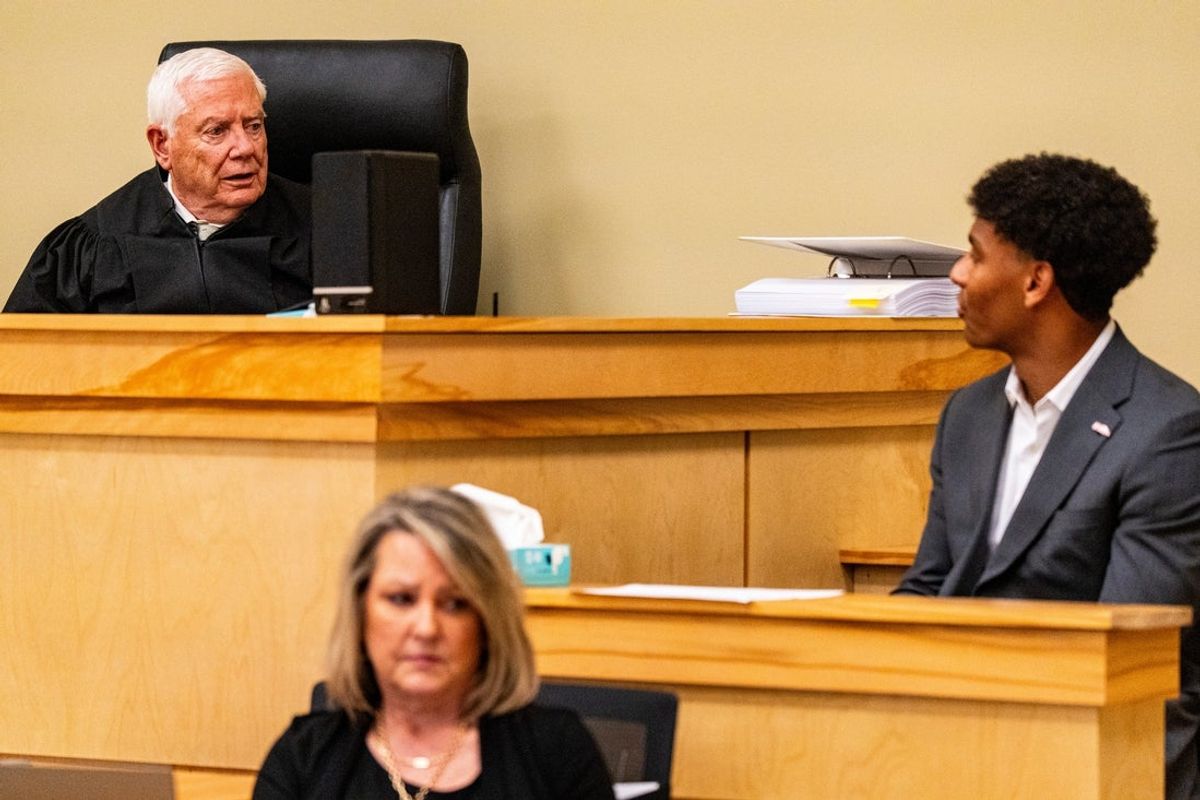 Lafayette County Chancery Court Judge Robert Whitwell, left, questions Ole Miss quarterback Trinidad Chambliss, right, during the hearing in his lawsuit against the NCAA at Calhoun County Courthouse in Pittsboro, Miss., on Thursday, Feb. 12, 2026. Chambliss is looking for a temporary injunction and a permanent injunction against the NCAA for one more year of eligibility.