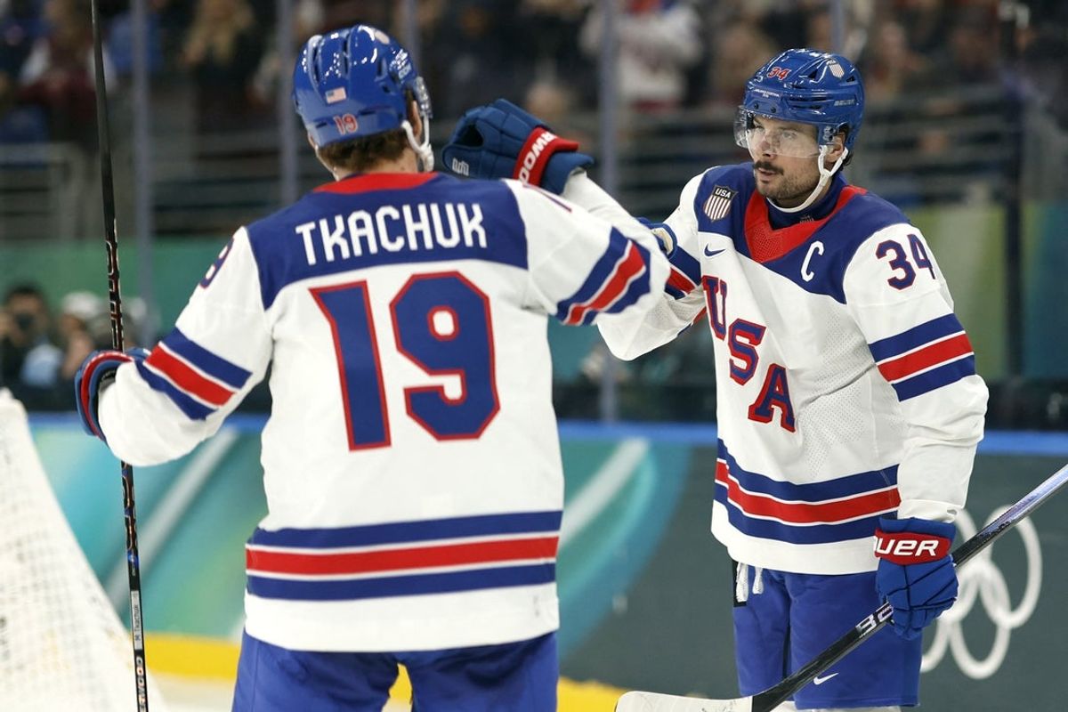Feb 12, 2026; Milan, Italy;  Auston Matthews of United States celebrates scoring their fifth goal with Matthew Tkachuk of United States against Latvia in men's ice hockey group C play during the Milano Cortina 2026 Olympic Winter Games at Milano Santagiulia Ice Hockey Arena. Mandatory Credit: Geoff Burke-Imagn Images