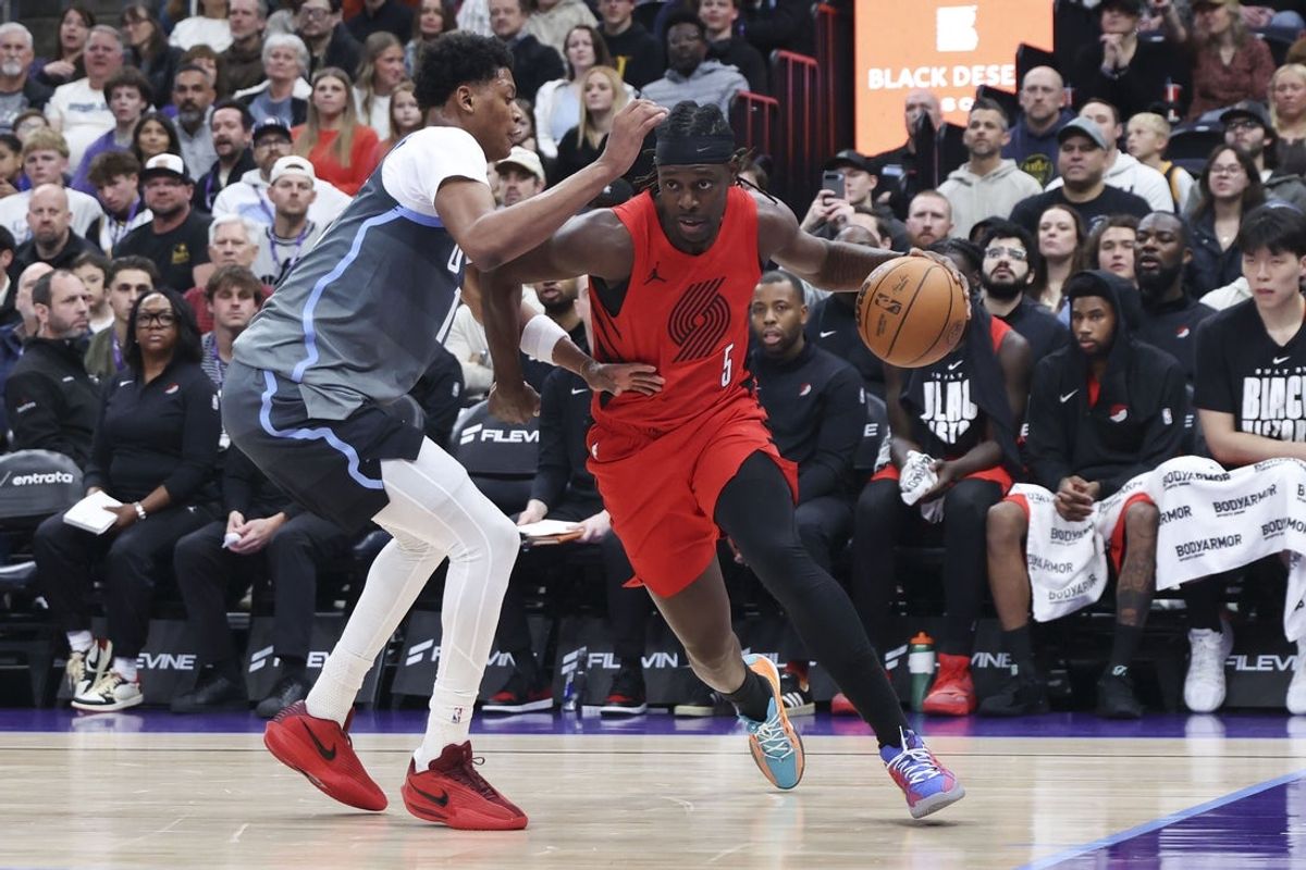 Feb 12, 2026; Salt Lake City, Utah, USA; Portland Trail Blazers guard Jrue Holiday (5) drives against Utah Jazz guard Ace Bailey (19) during the first half at Delta Center. Mandatory Credit: Rob Gray-Imagn Images