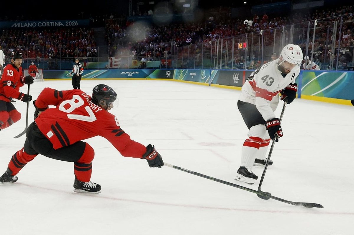 Feb 13, 2026; Milan, Italy; Andrea Glauser of Switzerland in action with Sidney Crosby of Canada  in men's ice hockey group A play during the Milano Cortina 2026 Olympic Winter Games at Milano Santagiulia Ice Hockey Arena. Mandatory Credit: Geoff Burke-Imagn Images