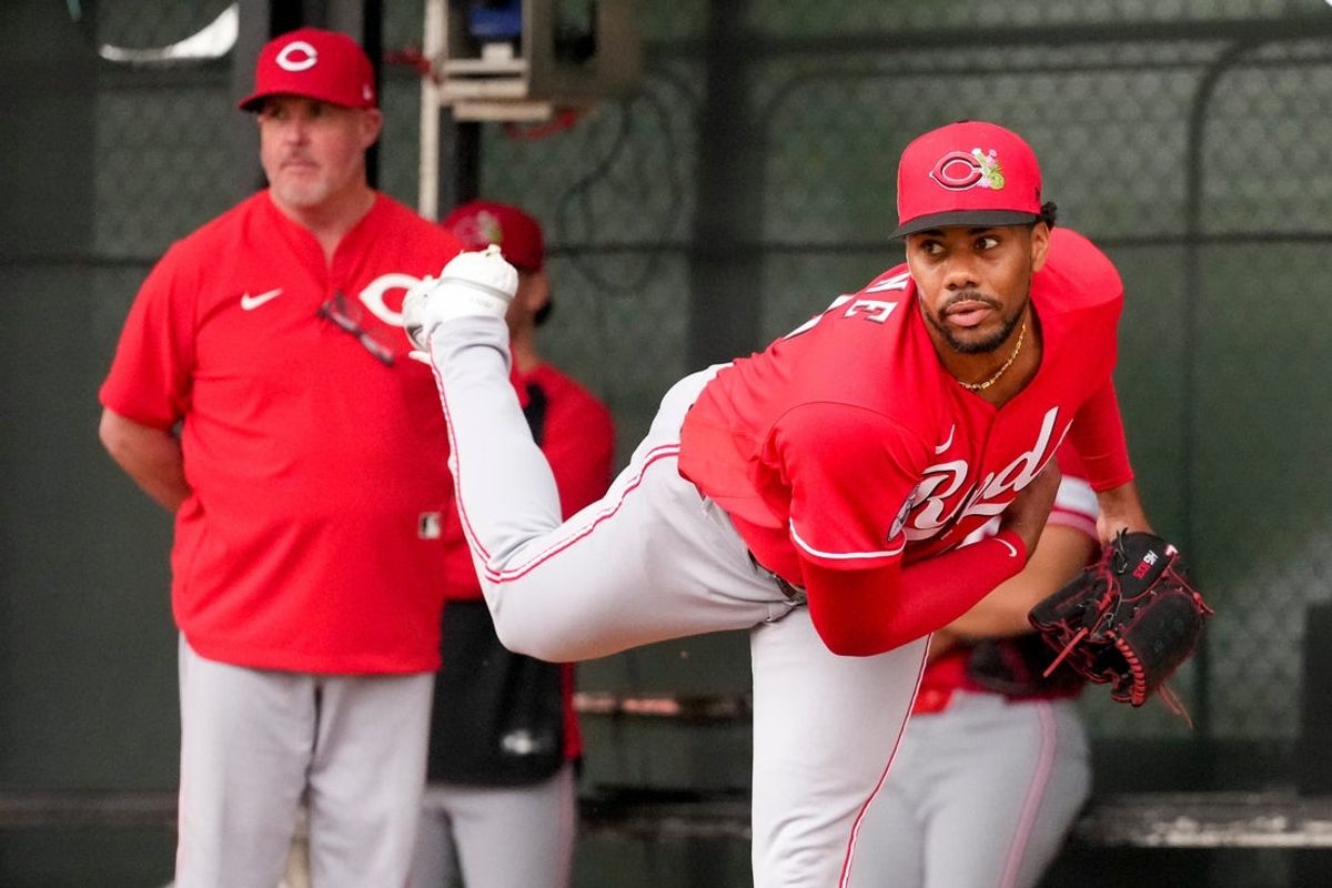 Cincinnati Reds pitcher Hunter Greene (21) throws a bullpen session with pitching coach/director of pitching Derek Johnson (36) at the Cincinnati Reds player development complex in Goodyear, Ariz., on Friday, Feb. 13, 2026.
