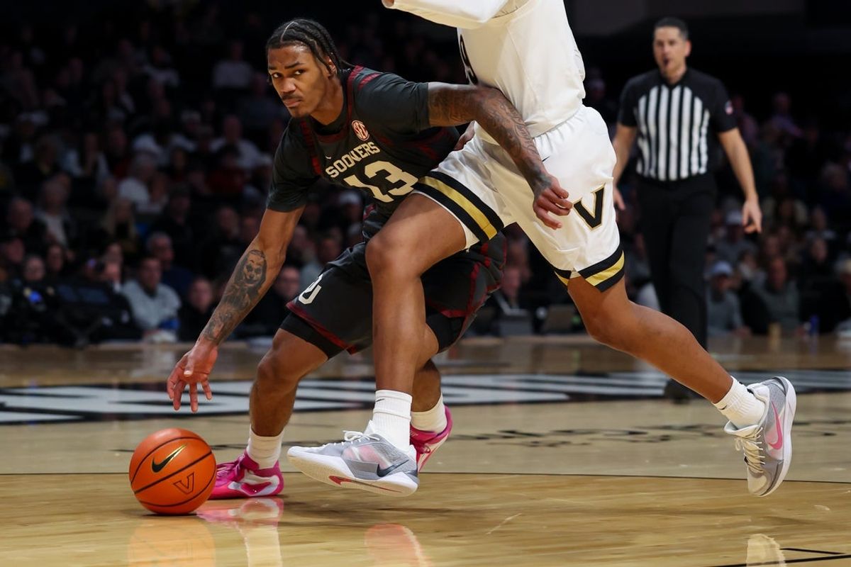 Feb 7, 2026; Nashville, Tennessee, USA;  Oklahoma Sooners forward Tae Davis (13) drives to the basket past Vanderbilt Commodores forward Devin McGlockton (99) during the first half at Memorial Gymnasium. Mandatory Credit: Steve Roberts-Imagn Images