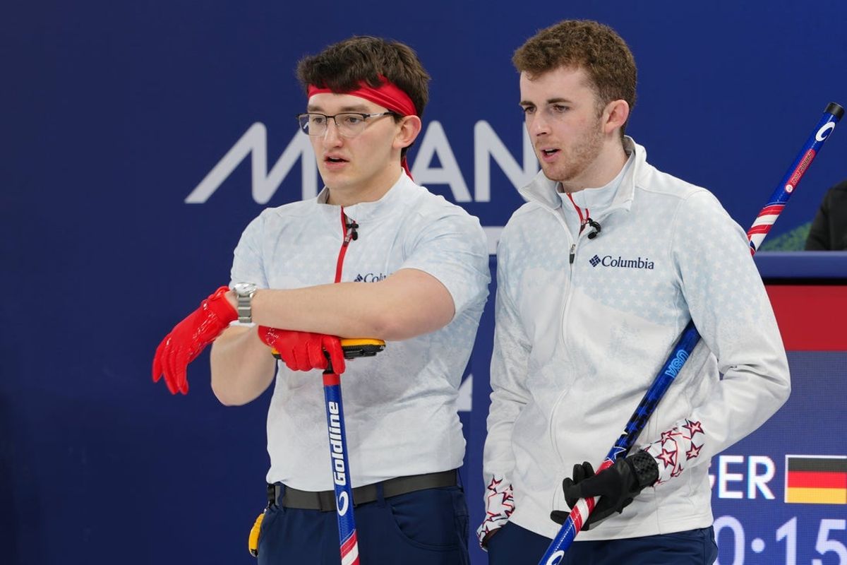 Feb 14, 2026; Cortina d'Ampezzo, Italy; Aidan Oldenburg and Daniel Casper of the United States look on during a men's curling round robin game during the Milano Cortina 2026 Olympic Winter Games at Cortina Curling Olympic Stadium. Mandatory Credit: Eric Bolte-Imagn Images