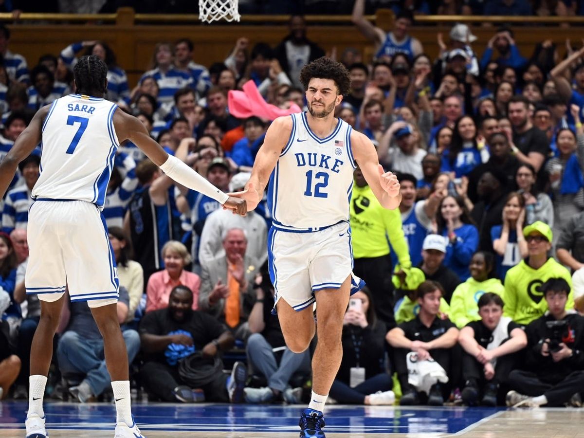 Feb 14, 2026; Durham, North Carolina, USA; Duke Blue Devils forward Cameron Boozer (12) is greeted by forward Dame Sarr (7) after scoring a basket during the first half against the Clemson Tigers at Cameron Indoor Stadium. Mandatory Credit: Rob Kinnan-Imagn Images